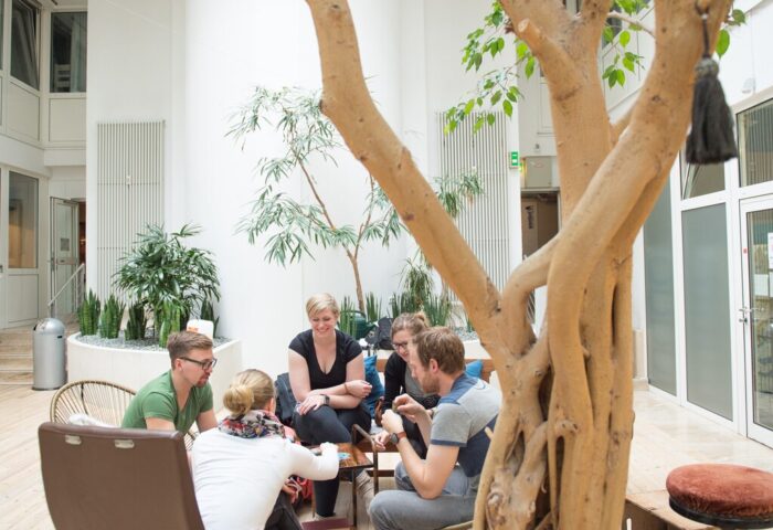 Wombats City Hostel Munich: Guests gather in the hostel's bright, plant-filled atrium. A gay-friendly hotel for travelers in Munich.