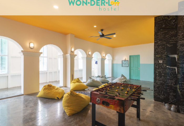 Wonderloft Hostel common area with foosball, beanbags, and blackboard. A gay-friendly hotel offering a social travel experience.
