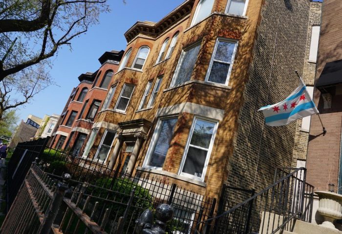 Wrigley Hostel, an adults-only, gay-friendly hotel in Chicago. View of the building's exterior with a Chicago flag waving.