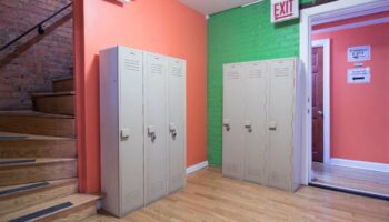 Lockers at Wrigley Hostel, an adults-only, gay-friendly hotel. Colorful walls and stairs. A safe and welcoming space for gay travelers.