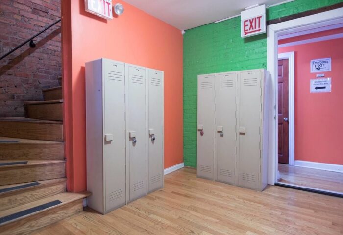 Lockers at Wrigley Hostel, an adults-only, gay-friendly hotel. Colorful walls and stairs. A safe and welcoming space for gay travelers.