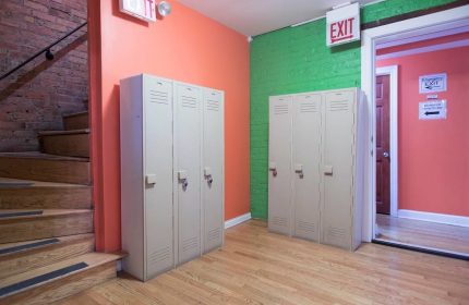 Lockers at Wrigley Hostel, an adults-only, gay-friendly hotel. Colorful walls and stairs. A safe and welcoming space for gay travelers.
