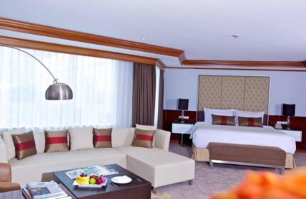 Wyndham Casablanca Jakarta gay-friendly hotel room. A luxurious suite with a king bed, sofa, and modern decor. Perfect for gay travelers.