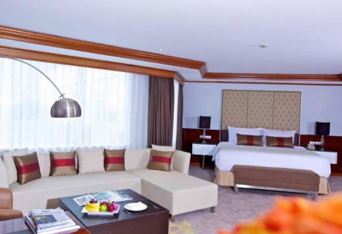 Wyndham Casablanca Jakarta gay-friendly hotel room. A luxurious suite with a king bed, sofa, and modern decor. Perfect for gay travelers.