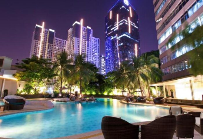 Wyndham Casablanca Jakarta gay-friendly hotel pool at night. Jakarta skyline view. Gay travel in Indonesia.