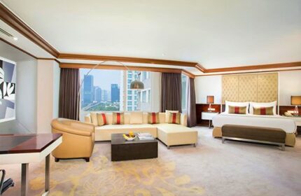 Wyndham Casablanca Jakarta gay-friendly hotel suite. Living area, city view, king bed. Upscale travel for gay men in Jakarta, Indonesia.
