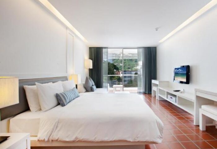 X2 Vibe Phuket Patong gay-friendly hotel room. Modern design, white bedding, balcony view. Ideal for gay men's travel in Phuket, Thailand.