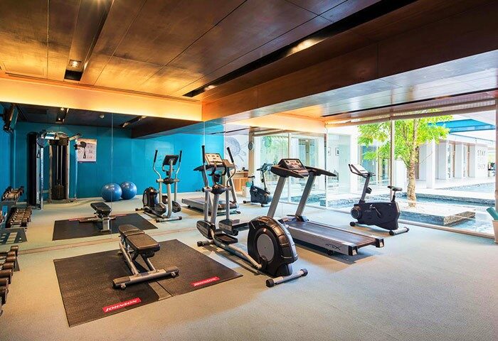 Gym at Gay-Friendly X2 Vibe Phuket Patong Hotel. Fitness center with treadmills, elliptical machines, weights, and exercise equipment.