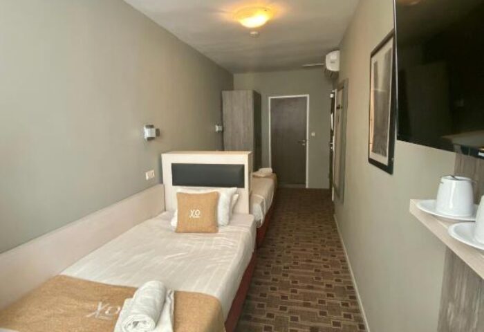 XO Hotels City Centre room. Twin beds, TV, and desk. Gay-friendly hotel offering comfortable accommodations in a central location.