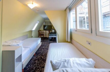XO Hotels City Centre room with twin beds. Gay-friendly hotel in Amsterdam. The room has a window and a TV. Perfect for gay travel.