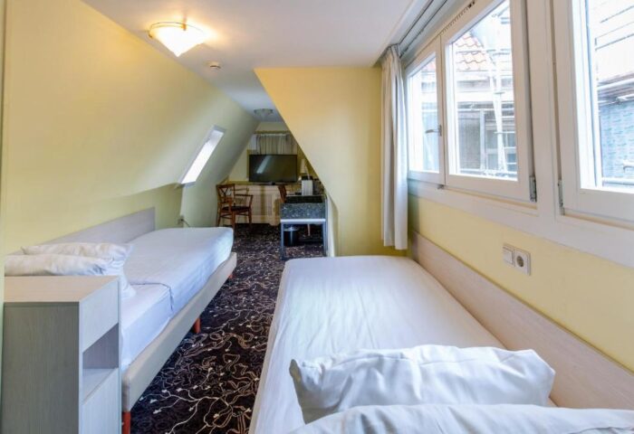 XO Hotels City Centre room with twin beds. Gay-friendly hotel in Amsterdam. The room has a window and a TV. Perfect for gay travel.