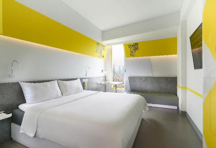YELLO Hotel Manggarai room. Gay-friendly hotel with double bed, yellow accents, and city view. Modern design for gay travelers in Jakarta.