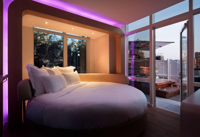 YOTEL New York Times Square room. Round bed, purple lighting, city view. Gay-friendly hotel. Perfect for gay men travel.