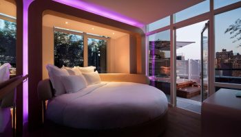 YOTEL New York Times Square room. Round bed, purple lighting, city view. Gay-friendly hotel. Perfect for gay men travel.