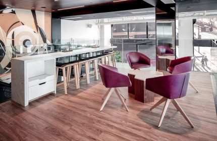 YOTEL San Francisco interior. Gay-friendly hotel with stylish seating area. Modern design with purple chairs and bar stools. Hotel interior.