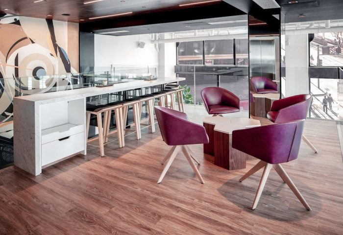 YOTEL San Francisco interior. Gay-friendly hotel with stylish seating area. Modern design with purple chairs and bar stools. Hotel interior.