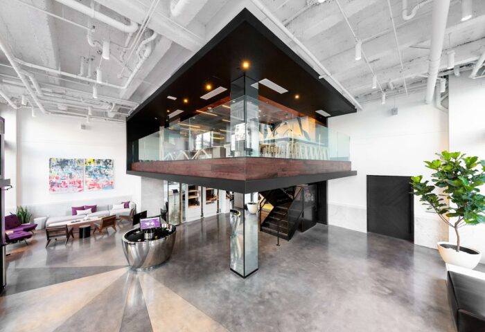 YOTEL San Francisco lobby. Modern interior design in this gay-friendly hotel. Features a mezzanine, lounge area, and sleek reception desk.