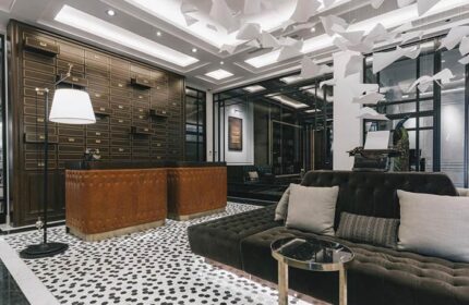 Yangon Excelsior Hotel lobby. Gay-friendly hotel with vintage decor, brown leather reception desk, and a comfortable lounge area. Stylish interior.
