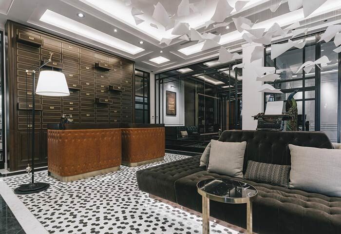 Yangon Excelsior Hotel lobby. Gay-friendly hotel with vintage decor, brown leather reception desk, and a comfortable lounge area. Stylish interior.