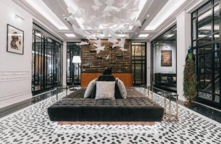 Yangon Excelsior: Gay-friendly hotel lobby with stylish decor, including a bird sculpture, peacock, and modern furniture. Great for gay travel.