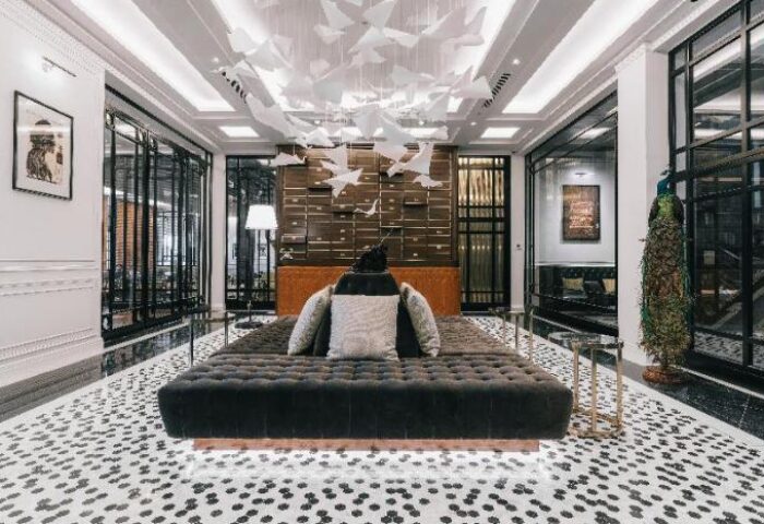 Yangon Excelsior: Gay-friendly hotel lobby with stylish decor, including a bird sculpture, peacock, and modern furniture. Great for gay travel.