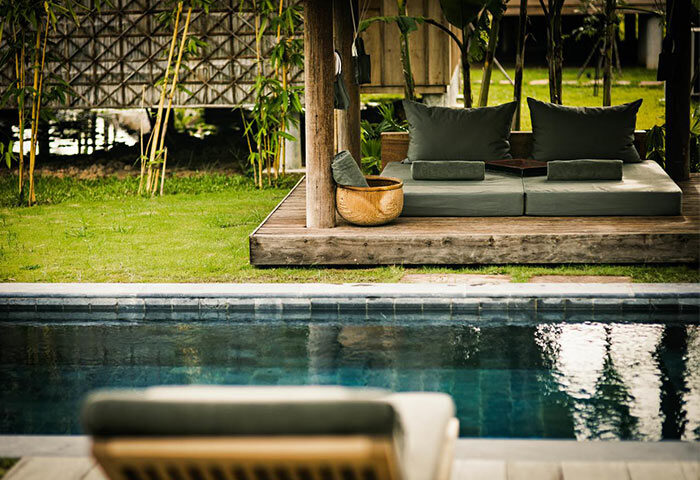 Zannier Hotels Phum Baitang gay-friendly hotel pool. Outdoor daybed with pillows near the pool. Gay travel luxury resort.