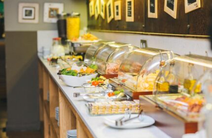 Zenit Budapest Palace gay-friendly hotel breakfast buffet. Food selection includes salad, cheese, meats, and cereals. A great start to your Budapest vacation.