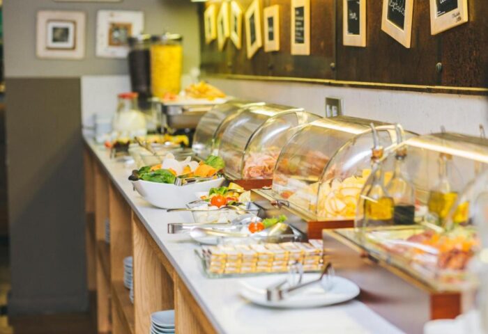Zenit Budapest Palace gay-friendly hotel breakfast buffet. Food selection includes salad, cheese, meats, and cereals. A great start to your Budapest vacation.