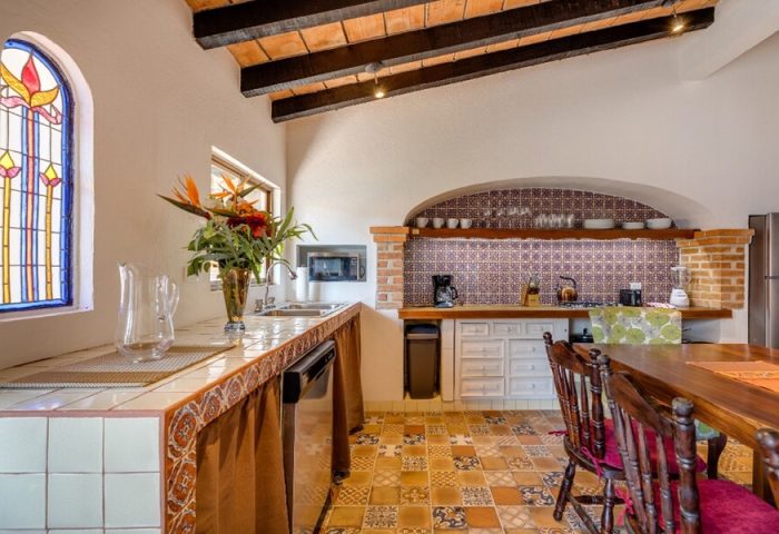 ZonaZ Boutique Hotel's kitchen. Gay-friendly hotel features colorful tile, stained glass, and rustic wood beams. Boutique hotel kitchen.
