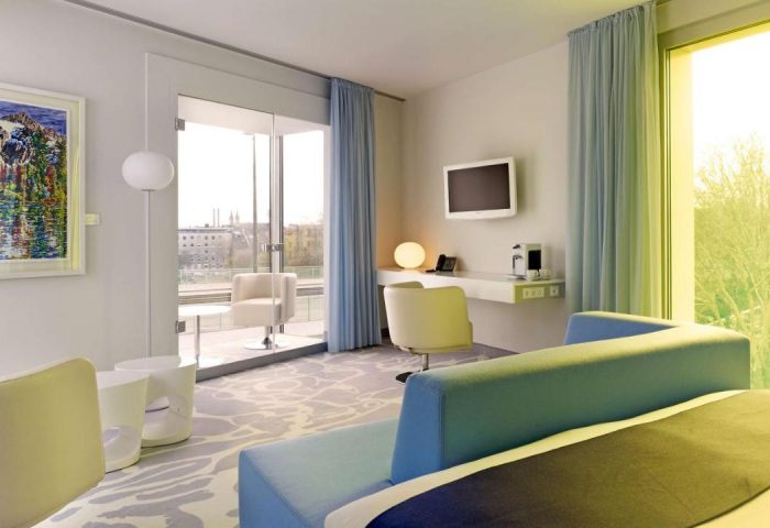 Art'otel Cologne by Park Plaza room. Gay-friendly hotel, part of Radisson Hotel Group, with modern decor, desk, and balcony for gay men travelers.