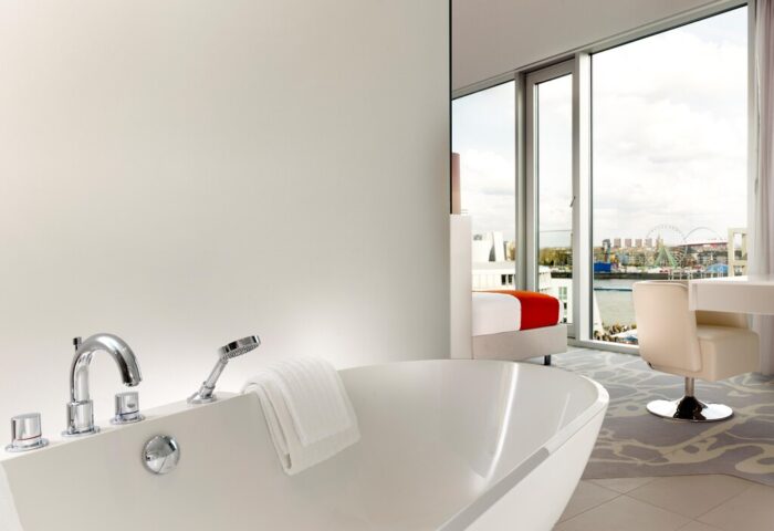 Art’otel Cologne by Park Plaza bathroom. Gay-friendly hotel room with bathtub, river view, and desk. Part of Radisson hotel group.