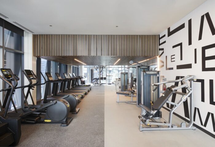 citizenM Chicago Downtown gay-friendly hotel gym. Treadmills, elliptical machines, and weight machines. Modern design, fitness center.