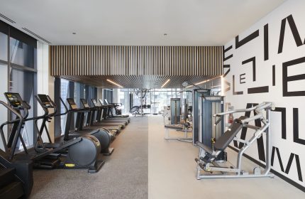 citizenM Chicago Downtown gay-friendly hotel gym. Treadmills, elliptical machines, and weight machines. Modern design, fitness center.