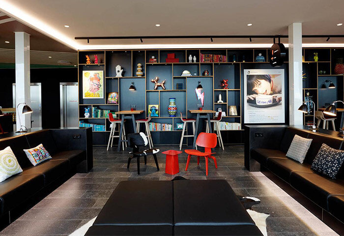 citizenM Copenhagen Radhuspladsen's stylish lobby. This gay-friendly hotel features modern decor, colorful art, and comfortable seating.