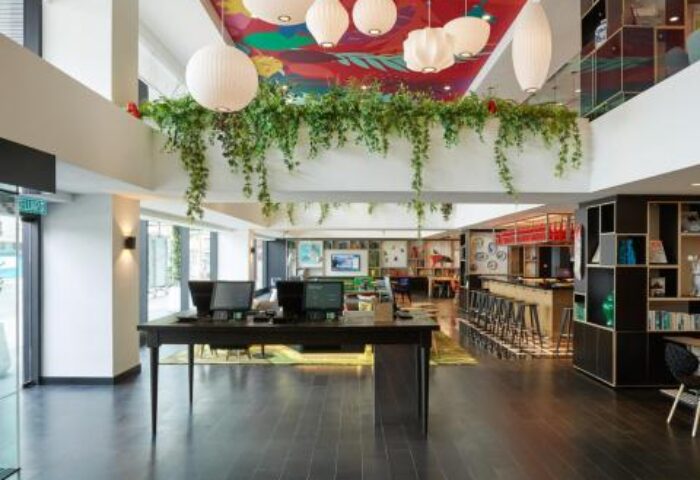 citizenM Kuala Lumpur Bukit Bintang lobby. Gay-friendly hotel interior with colorful ceiling art, modern design, and welcoming atmosphere.