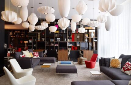 citizenM London Bankside hotel lobby with modern design. Gay-friendly hotel with stylish furniture and lighting. Perfect for gay travel.