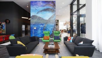 citizenM Los Angeles Downtown hotel lobby with colorful modern furniture. Gay-friendly hotel lounge area. Downtown LA hotel interior.