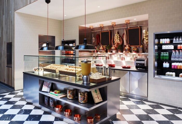 citizenM Los Angeles Downtown hotel's stylish deli area. This gay-friendly hotel features a modern design with a black-and-white checkered floor.