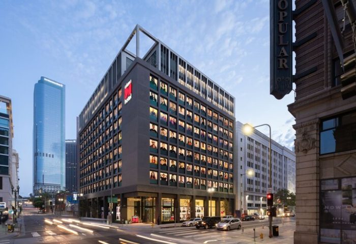 citizenM Los Angeles Downtown hotel exterior. Gay-friendly hotel architecture in LA. Modern design, street view, and city skyline.