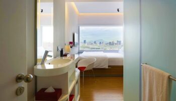 citizenM Taipei North Gate hotel room. Modern design, city view. Gay-friendly hotel in Taipei. Bathroom and bedroom in one open space.