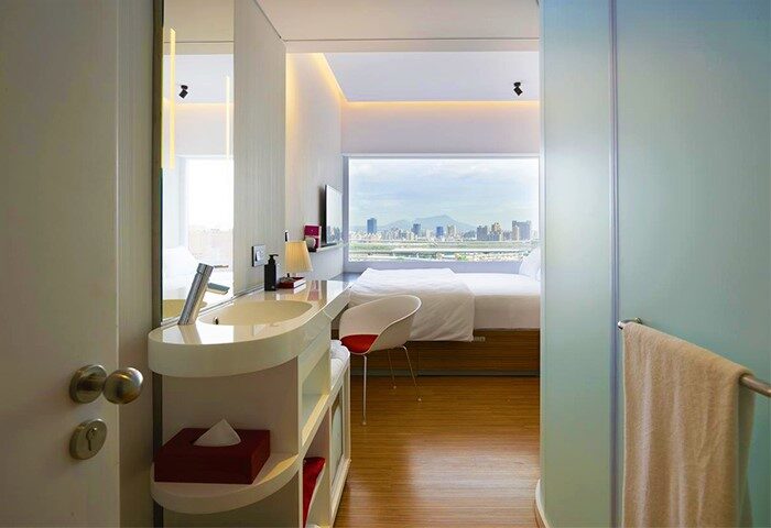 citizenM Taipei North Gate hotel room. Modern design, city view. Gay-friendly hotel in Taipei. Bathroom and bedroom in one open space.