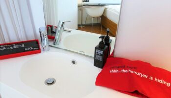CitizenM Taipei North Gate gay-friendly hotel bathroom sink, soap dispenser, and hairdryer bag. Modern design for gay travelers in Taipei.