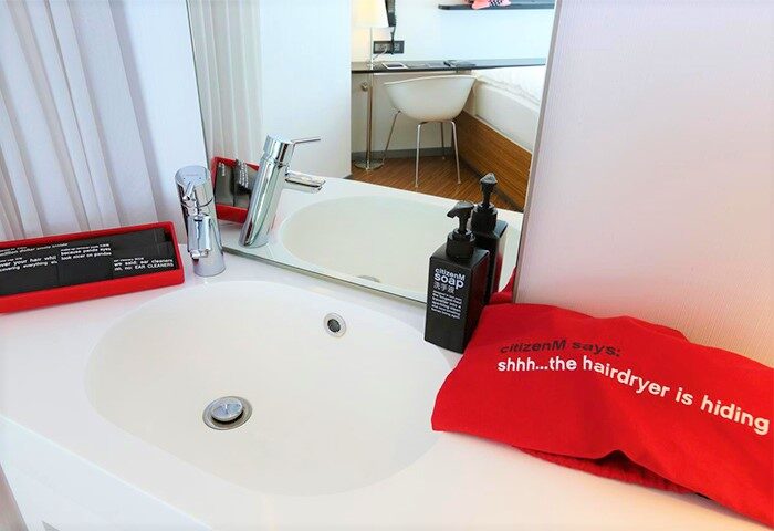 CitizenM Taipei North Gate gay-friendly hotel bathroom sink, soap dispenser, and hairdryer bag. Modern design for gay travelers in Taipei.