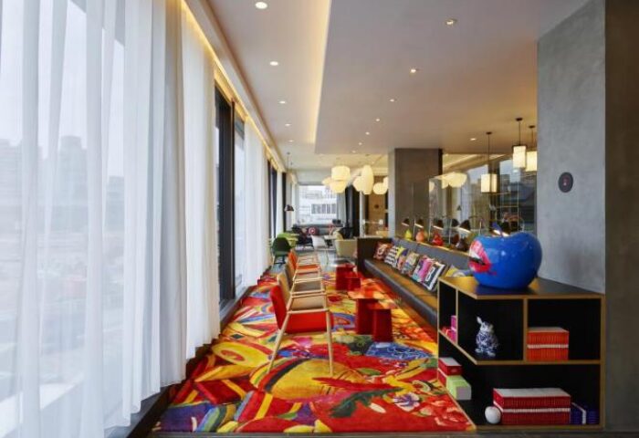 citizenM Taipei North Gate's stylish lounge area. This gay-friendly hotel features colorful decor, modern seating, & unique design elements.