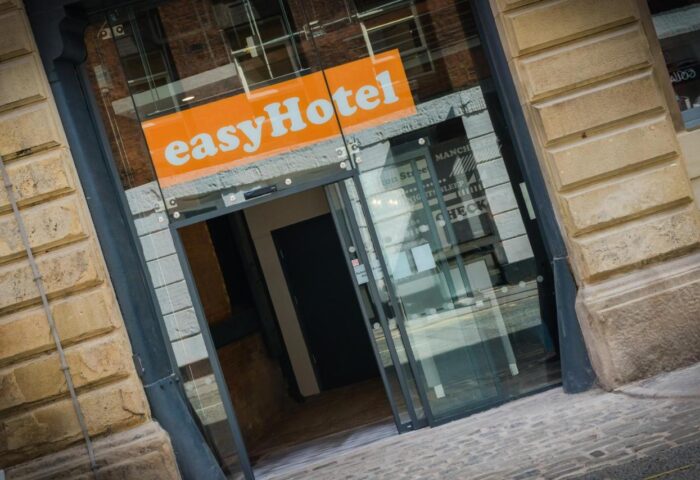 Entrance to easyHotel Manchester, a gay-friendly hotel. Glass doors, orange easyHotel sign. A great choice for gay travelers in Manchester.