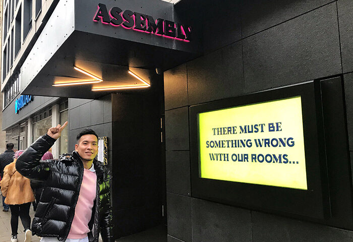 Assembly Hotel, gay-friendly hotel in London. A gay traveler points to the hotel's sign, There must be something wrong with our rooms...