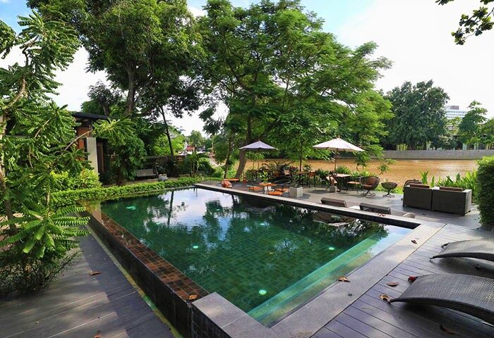 i-river Chiangmai gay-friendly hotel pool view. Relaxing riverside setting for gay travelers in Chiangmai, Thailand. Lush, tropical getaway.
