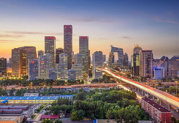 Beijing skyline at dusk near Ibis Beijing Tuanjiehu, a gay-friendly hotel. Cityscape view with modern buildings and vibrant lights.