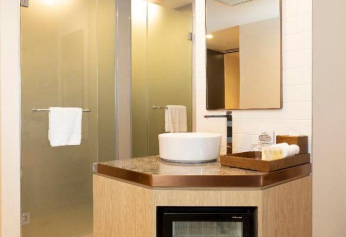 Bathroom at ibis Melbourne Central, a gay-friendly hotel. Features a modern sink, shower, mirror, and amenities. Ideal for gay travelers.