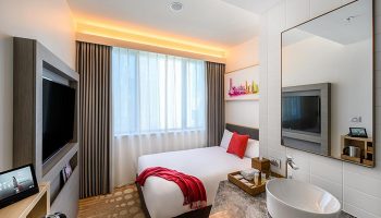 Ibis Melbourne Central hotel room. Modern design with bed, TV, and stylish bathroom. Gay-friendly accommodation in Melbourne, Australia.